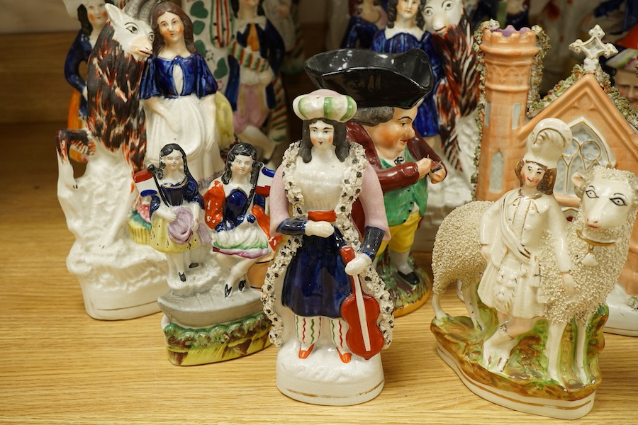 A collection of Victorian Staffordshire pottery figures, largest 32cm high